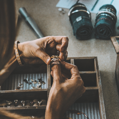 Hands of a woman working on the craft of jewelry 